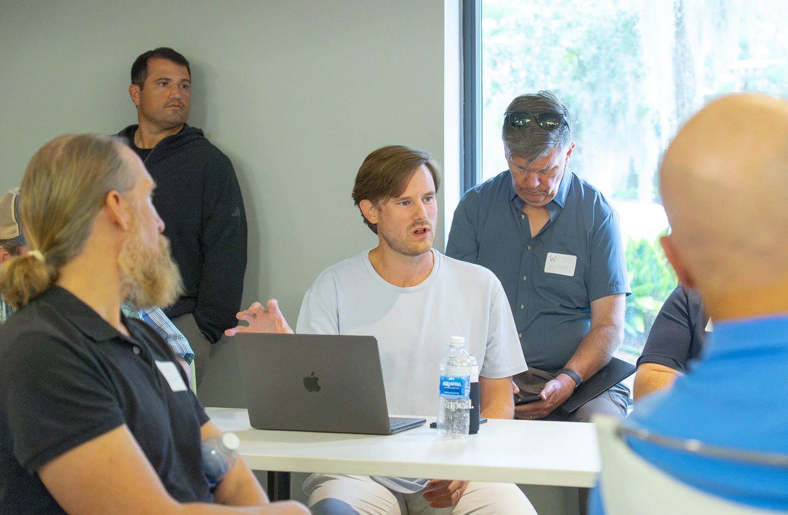 An attendee talking at a laptop during the August 27, 2026 AI Roundtable.