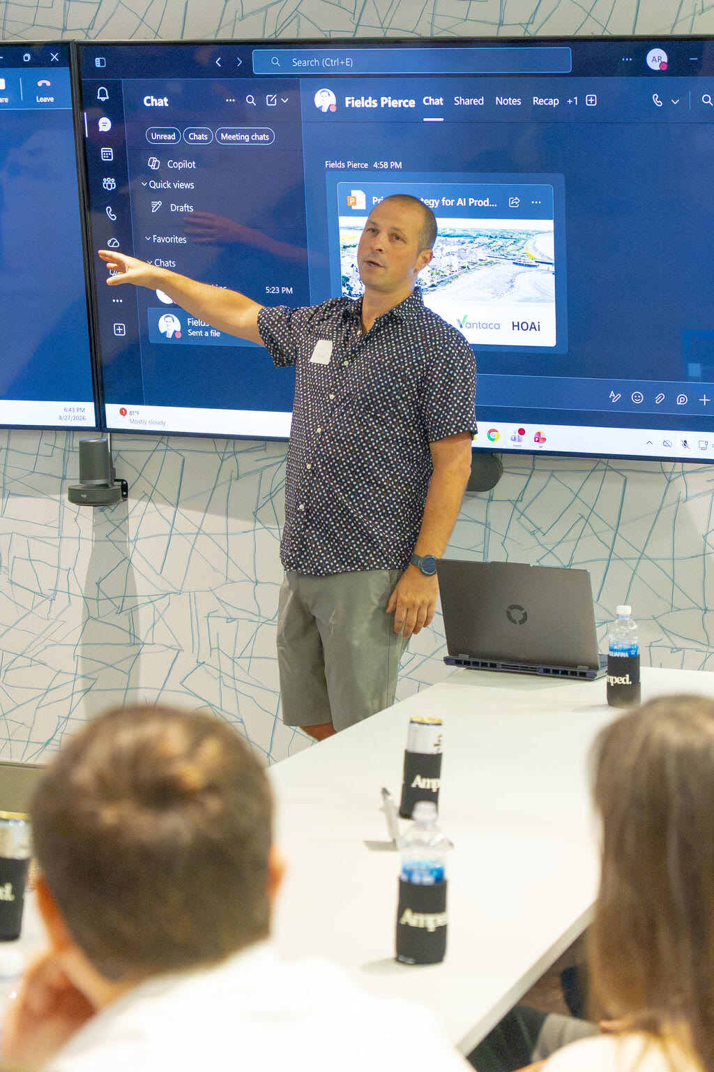 A speaker presenting in front of a screen at the August 27, 2026 AI Roundtable.