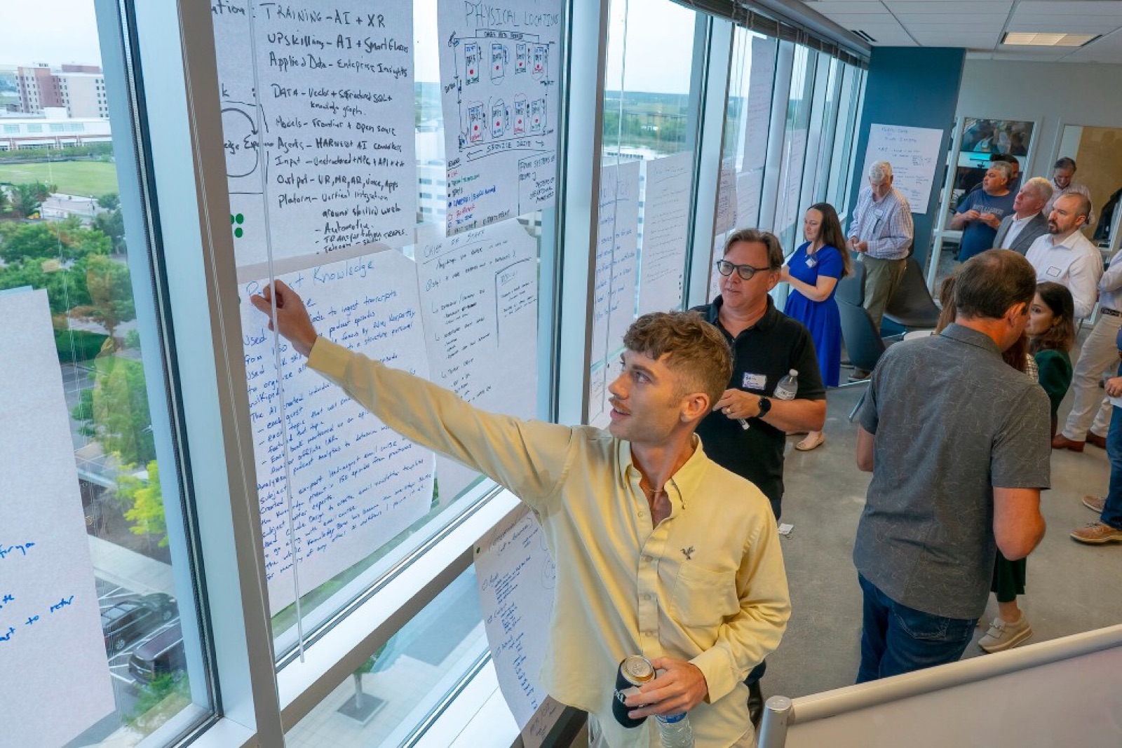 A builder walking through his concept on the window whiteboard.